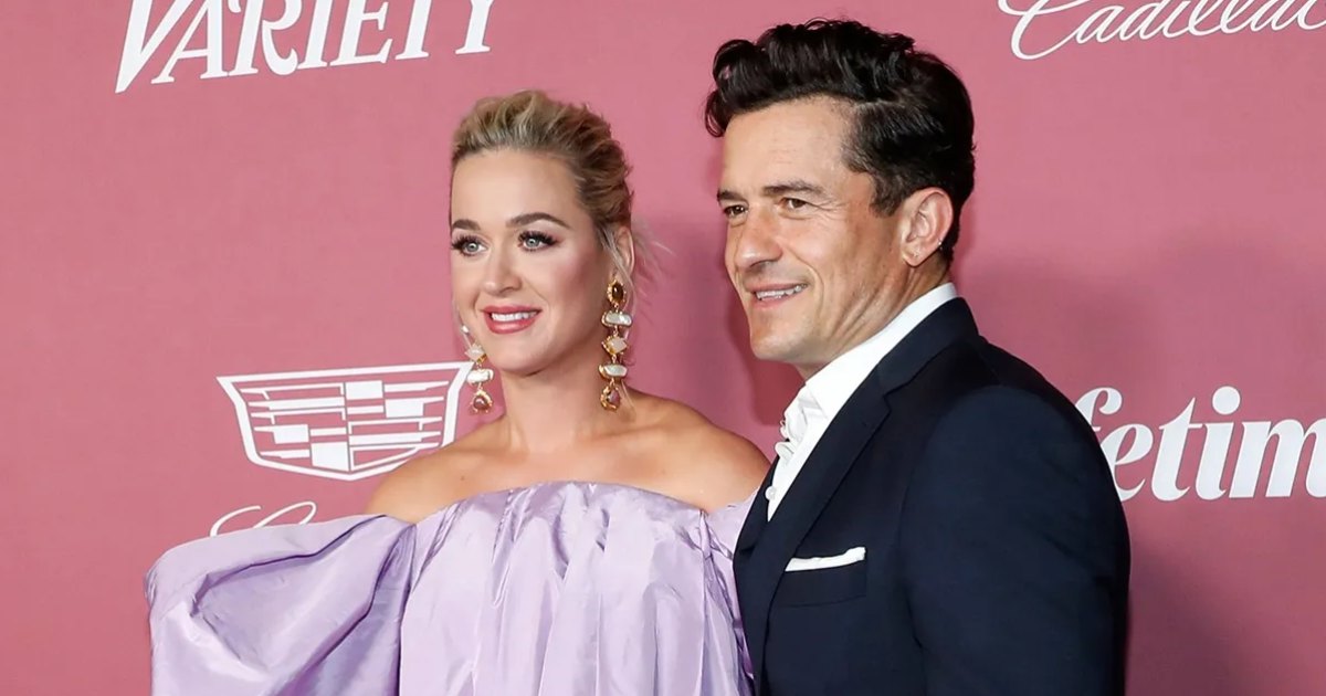 Orlando Bloom helps Katy Perry fix her dress at the Power of Women event